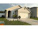 Charming single-story home with a well-manicured lawn and attached two-car garage at 1940 Egret Meadows Ave, Kissimmee, FL 34744