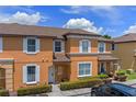 Charming two-story townhome with a well-manicured lawn and neatly trimmed shrubbery at 2708 Camaro Dr, Kissimmee, FL 34746