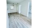 Bright and airy living room featuring wood-look flooring, neutral walls, and ample natural light at 329 N Hart Blvd, Orlando, FL 32835