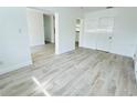 Spacious living room with wood-look flooring, freshly painted walls, and modern design at 329 N Hart Blvd, Orlando, FL 32835