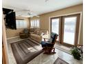 Cozy living area with double doors leading to the outside and a comfortable seating arrangement at 3407 Santa Monica Dr, Orlando, FL 32822