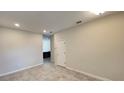 View of a neutral living room with tile floors and recessed lighting at 4634 Tribute Trl, Kissimmee, FL 34746