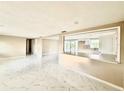 Bright living space with open layout, white cabinets, breakfast bar and modern marble-patterned tile flooring at 4917 Easton St, Lake Wales, FL 33859