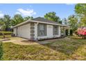 Well-kept exterior featuring charming details and gray trim, and an attached two-car garage at 511 Mobley Dr, Deltona, FL 32725