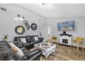 Cozy living room with a decorative fireplace, hardwood flooring, and modern decor at 511 Mobley Dr, Deltona, FL 32725