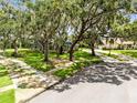 Beautiful home surrounded by mature trees and a well-manicured lawn at 5204 Hammock Pointe Ct, St Cloud, FL 34771