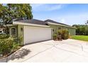 Spacious two-car garage with a large driveway and well-maintained landscaping at 5204 Hammock Pointe Ct, St Cloud, FL 34771