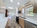 Modern kitchen featuring stainless steel appliances and marble countertops, seamlessly connected to the living area at 5312 Kingswood Dr, Orlando, FL 32810