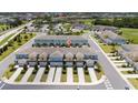 Aerial view showcasing the community's colorful townhouses, green spaces, and convenient parking, emphasizing the desirable location at 7920 Draw St, Reunion, FL 34747