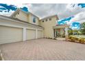 Spacious two-story home with a three-car garage and brick driveway for ample parking at 7971 Brofield Ave, Windermere, FL 34786