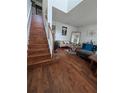 Inviting living area featuring hardwood floors, a staircase, and stylish decor at 7971 Brofield Ave, Windermere, FL 34786