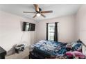 Comfortable bedroom with a ceiling fan, and a window providing natural light at 8 Orchid Ct, Kissimmee, FL 34759