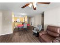 Cozy living room featuring sleek wood floors, a comfortable seating area, and an open layout at 8 Orchid Ct, Kissimmee, FL 34759