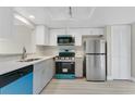 Updated kitchen boasts stainless steel appliances and quartz countertops at 12155 Pepperdine Pl, Orlando, FL 32826