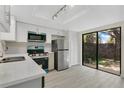 Renovated kitchen featuring stainless steel appliances and sliding glass doors to the backyard at 12155 Pepperdine Pl, Orlando, FL 32826