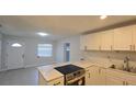 Bright kitchen with stainless steel appliances, white cabinets and stone countertops at 1415 Zenith Pl, Orlando, FL 32808