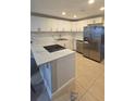 Contemporary kitchen with white cabinetry, stainless appliances, and ample counter space at 1415 Zenith Pl, Orlando, FL 32808