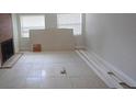 Living room with fireplace, tile flooring, and bright windows at 1415 Zenith Pl, Orlando, FL 32808