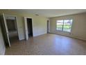 Bedroom featuring tile floors, a window and an open closet space at 15 Clear Way, Ocala, FL 34472