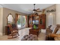 Comfortable living room with tile floors and french doors to the pool at 1525 Gants Cir, Kissimmee, FL 34744