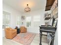 Bright room with white walls, a decorative rug, stylish furnishings, and a window with shutters at 1855 Treasure Cv, Kissimmee, FL 34747