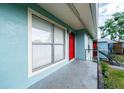 Apartment balcony with light blue siding and a red door at 1891 Caralee Blvd # 3, Orlando, FL 32822