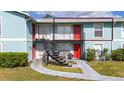 Apartment building with access stairs, red doors and light blue exterior at 1891 Caralee Blvd # 3, Orlando, FL 32822