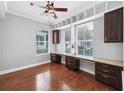 Bright home office with custom built-in shelving, ample workspace, and hardwood floors for a professional setting at 205 N Village St, Celebration, FL 34747