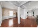 Spacious living room with hardwood floors, decorative columns, and large windows for plenty of natural light at 205 N Village St, Celebration, FL 34747