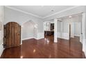 Elegant living room with hardwood floors, architectural details, and an open layout flowing into the kitchen at 205 N Village St, Celebration, FL 34747