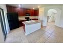 Modern kitchen with stainless steel appliances, dark cabinets, and tile flooring at 2243 Seven Oaks Dr, St Cloud, FL 34772