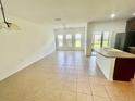 Bright and airy living space features tile flooring and an open floor plan at 2243 Seven Oaks Dr, St Cloud, FL 34772