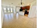 Open-concept living and dining area features tile floors, a ceiling fan, and natural light at 2243 Seven Oaks Dr, St Cloud, FL 34772
