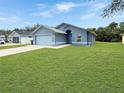 This cozy home includes a well-kept lawn, a 2-car garage, and a driveway for convenient parking at 2444 Oak Mill Dr, Kissimmee, FL 34744