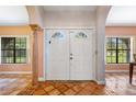 Elegant foyer features a double door, decorative tile flooring, arched entries, and windows offering bright natural light at 2695 Hilliard Ct, Kissimmee, FL 34744