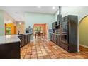 Modern kitchen with stainless steel appliances, granite countertops, tile flooring, and a breakfast nook area at 2695 Hilliard Ct, Kissimmee, FL 34744