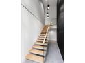 Modern staircase featuring light wood treads, sleek railing, and distinctive black accent wall at 3807 S Semoran Blvd, Orlando, FL 32822