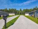 Street view showcasing the driveway and mailboxes of adjacent homes, surrounded by lush greenery and trees at 536 Bristol Cir, Kissimmee, FL 34758