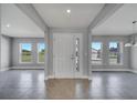 Light and airy foyer features sleek gray walls and tile flooring, plus lots of natural light at 547 Viceroy Ct, Kissimmee, FL 34758
