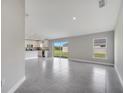 Bright, open-concept living space featuring sliding glass doors and tile flooring, blending indoor-outdoor living at 549 Viceroy Ct, Kissimmee, FL 34758