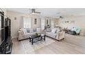 Spacious living room featuring lots of natural light, modern flooring, ceiling fans, and neutral decor at 609 Doheny Way, Casselberry, FL 32707