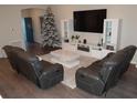 Modern living room featuring a large television, sleek entertainment center, and comfortable seating at 621 Vittorio Dr, Winter Haven, FL 33884