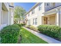 Inviting townhouse exterior with manicured landscaping and a walkway leading to the front door at 7110 Red Lantern Dr # 23, Harmony, FL 34773