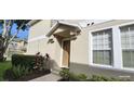 Charming front entrance with covered porch and neatly landscaped front yard at 7110 Red Lantern Dr # 23, Harmony, FL 34773