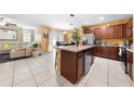 Open-concept kitchen with island and stainless steel appliances flowing into the living and dining areas at 739 Jefferson, Davenport, FL 33837