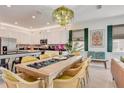Bright dining area connected to a modern kitchen featuring a breakfast bar and stainless appliances at 7458 Gathering Dr, Kissimmee, FL 34747