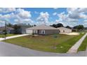 Corner lot featuring a well-manicured lawn with an attached two-car garage at 761 Parrot Ct, Kissimmee, FL 34759