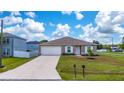 Charming single-story home featuring a well-manicured lawn and attached two-car garage at 761 Parrot Ct, Kissimmee, FL 34759