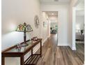Inviting entryway showcasing wood floors, a decorative mirror, console table, and lots of natural light at 7834 Stoney Bay Loop, Kissimmee, FL 34747