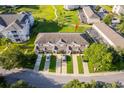 An aerial view showcasing the townhome with the community's green spaces at 8112 Princess Palm Ln, Kissimmee, FL 34747